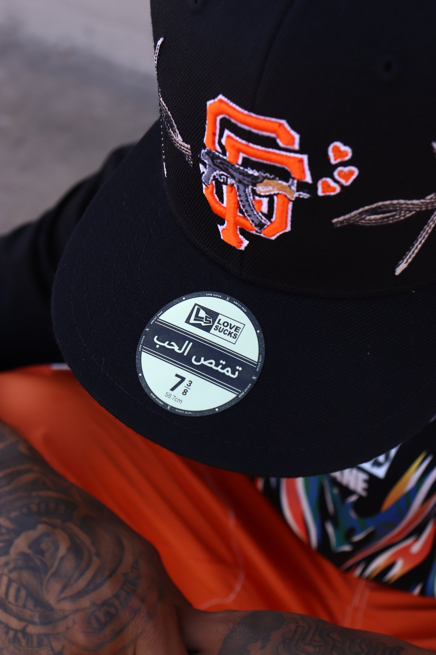 LOVE SUCKS BARBWIRE FITTED CAP in BLACK/ORANGE